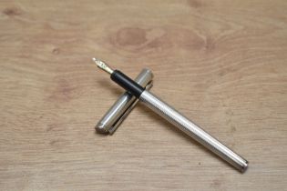 A Dunhills Slimline cartridge fountain pen in white metal having Dunhill 14K nib. In very good