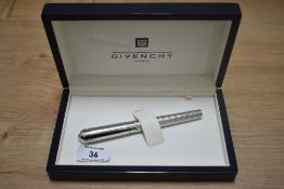 A boxed Givenchy cartridge fountain pen in white metal reeded design having a 18c nib