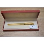 A boxed S T Dupont Fidelio gold plated cartridge fountain pen having 14k Dupont nib