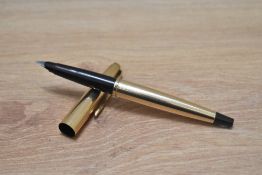 A Parker 45 Insignia aero fill fountain pen in gold fill with black tassie