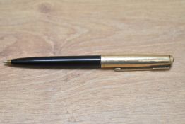 A Parker 61 ballpoint pen in black with gold fill cap