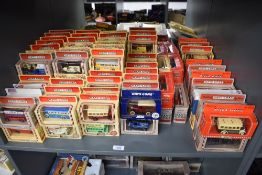 A shelf of Lledo Days Gone die-casts, Vintage Vans, Buses and Cars, all in window display boxes,