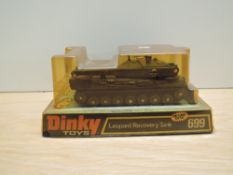 A Meccano Dinky die-cast, 699 Leopard Recovery Tank, on bubble card display stand and appears