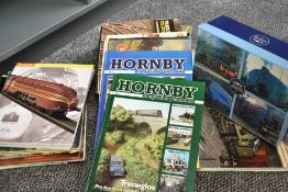 A shelf of Railway related Books and Magazines, mainly Hornby along with a 4 ceramic Cup set by