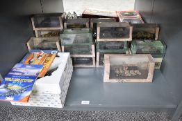 A shelf of Atlas die-casts, Military Tanks, Vehicles and Aircrafts, all in window display boxes or