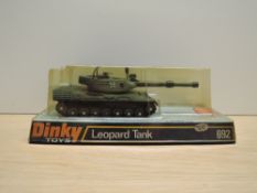A Meccano Dinky die-cast, 692 Leopard Tank with plastic bombs, on bubble card display stand and