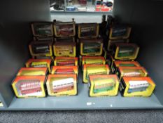 A shelf of 1983 Corgi die-cast Buses, Suntrekker, Routemaster and similar, all in yellow, red &