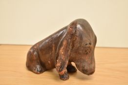 An early 20th century hand made leather study of a seated Bassett Hound by H.E.JACKMAN, on base Hand