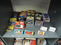 A shelf of modern die-casts including Solido No 53 Ford Fiesta x2 in red and silver, Zyimax D40 Mini