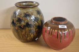 A mid-20th Century studio pottery vase, decorated with a repeating floral design, measuring 24cm