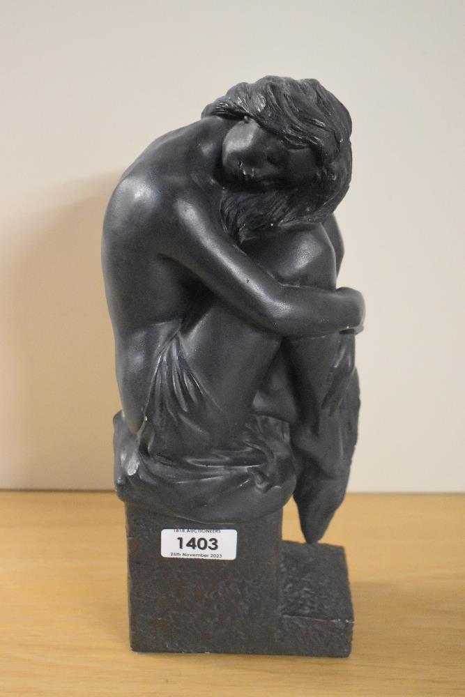 A modern bronze effect sculpture, stamped 'Austin Sculpture' to the base, and depicting a seated