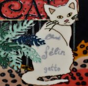 An assorted collection of decorative art and coloured prints, including a glazed ceramic cat