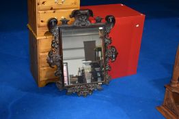 A 19th Century oak frame mirror, having foliate and interesting handshake design (possibly masonic