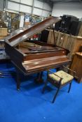 An early 20th Century mahogany cased baby grand piano by Steck having metal overstrung frame,