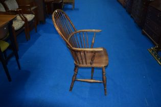 A 19th Century Windsor armchair having turned frame with H stretcher, joints a little loose