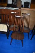 A set of three dark stained Ercol high back kitchen chairs