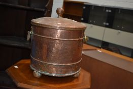 A traditional copper coal bucket having brass ring handles