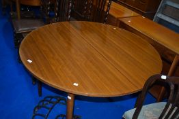 A vintage extending dining table having circular top , diameter 112cm, extending to 152cm