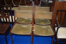 A set of four vintage teak framed designer armchairs, possibly G plan