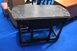 A 19th Century gateleg table having carved decoration, approx dimensions W114, D97, H76cm