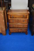A reproduction Regency style yew wood chest of drawers having fold over top, approx. dimensions