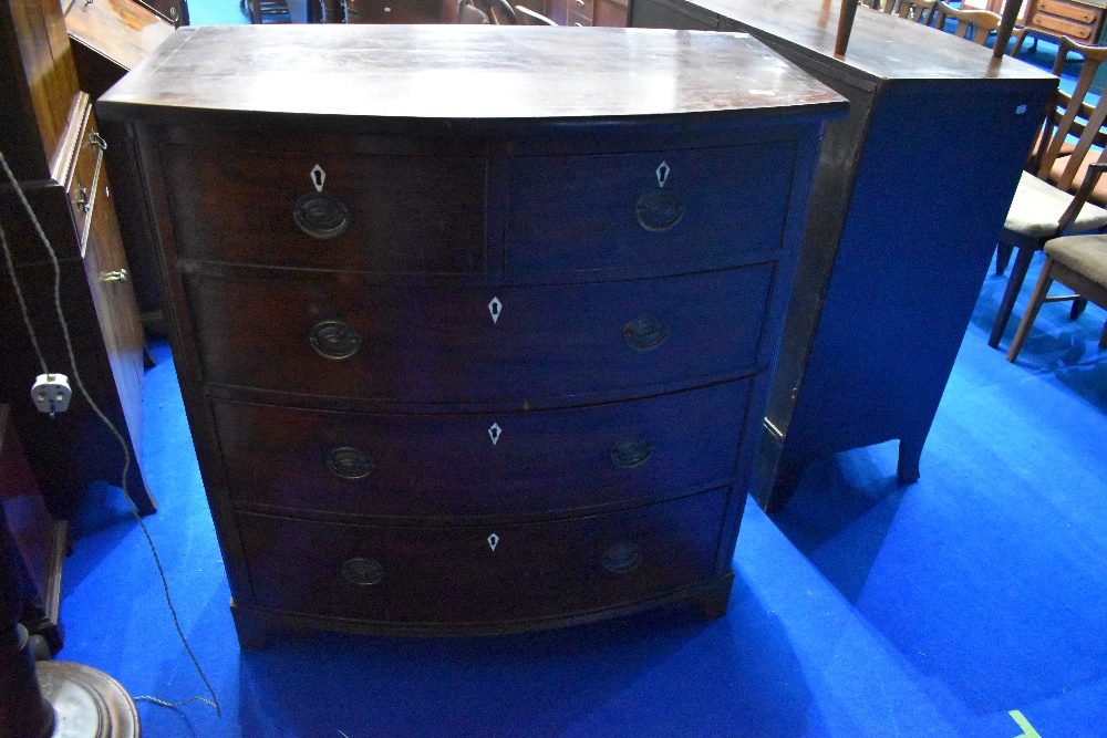 A 19th Century mahogany bow fronted chest of two over three drawers having Regency style handles