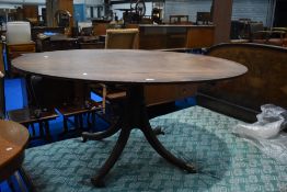 A Regency mahogany dining table having oval top on quadruple splay legs, approx 149 x 118cm