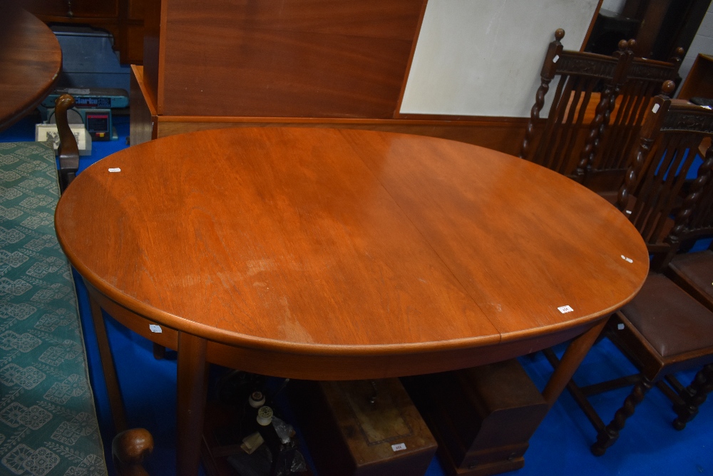 A vintage teak dining tabe, G plan or similar, of oval form, width 91cm, length approx. 153cm,