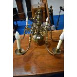 A vintage brass electrolier ceiling light fitting , having 6 branches and mythical figurehead