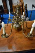 A vintage brass electrolier ceiling light fitting , having 6 branches and mythical figurehead