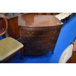 A reproduction Regency style bow front chest of four long drawers, with brushing slide, width