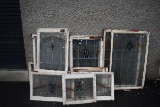 A selection of vintage windows in frame, with stained glass panels