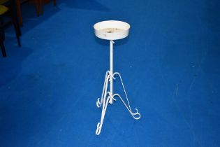 A vintage metal torchere or plant stand