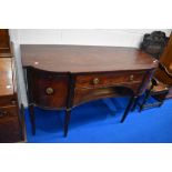 A Regency mahogany sideboard having central drawer above recess , flanked by cupboard , cellarette