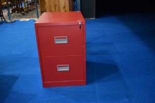 A modern metal two drawer filing cabinet in red