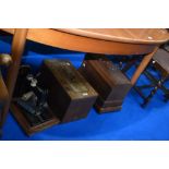 Two vintage sewing machines in cases