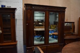 An Edwardian mahogany two piece bedroom suite comprising mirror door wardobe and dressing table,