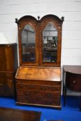 A fine Queen Anne walnut bureau , having double arch topped, Italian style mirrored panels to doors,