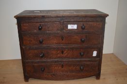 A 19th oak apprentice miniature chest of drawers, having two short and three long drawers, knob