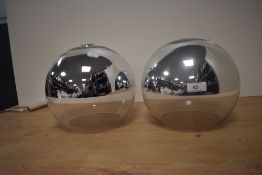 A pair of contemporary glass spherical light shades with chrome finish, measuring 21cm tall