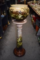 A late 19th Century Leeds pottery jardiniere on stand, in the aesthetic design, having a shaded
