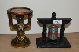 Two pieces of reproduced ethnic art, including a resin figural stand