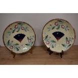 Two Victorian Majolica plates, having moulded decoration of basket weave, with fan to centre, bees