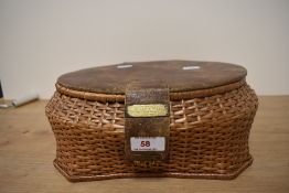 An early 20th Century wicker basket, with leather lid, and applied brass presentation plaque,