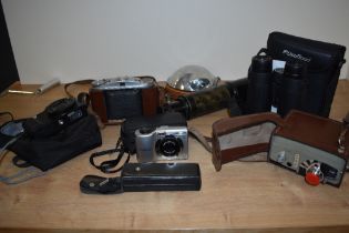 A vintage telescope, a Eumig camcorder, a vintage flash and a selection of modern cameras