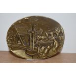 A solid brass commemorative WW2 paperweight, relief moulded to the top with a D-Day scene, inscribed