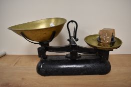 A set of vintage cast metal and brass scales with weights.