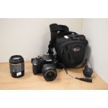 A Canon EOS 450D DSLR camera, a Tamron lens, and a camera bag