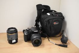 A Canon EOS 450D DSLR camera, a Tamron lens, and a camera bag