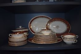 A quantity of John Maddock & Sons Ivory Ware ruby and gold coloured dinnerware